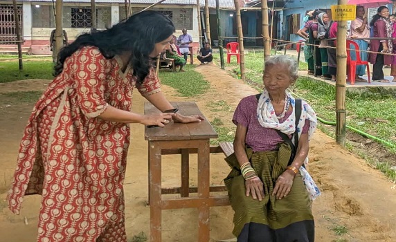 VC polls: North Tripura DM Chandni Chandran interacts with an elderly voter at Jubarajnagar during polling. 